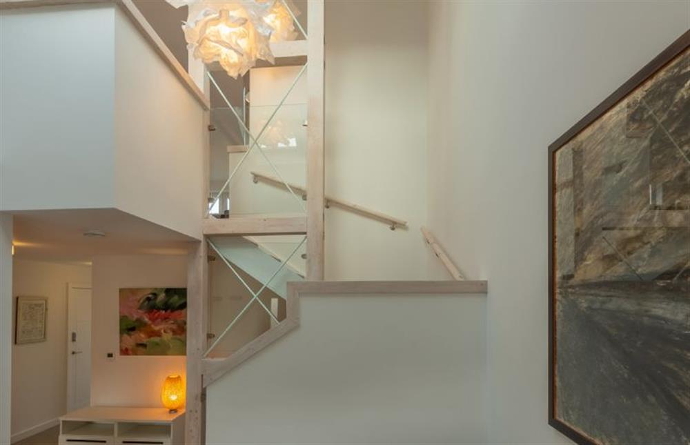 Ground floor: Dramatic staircase leading to first floor
