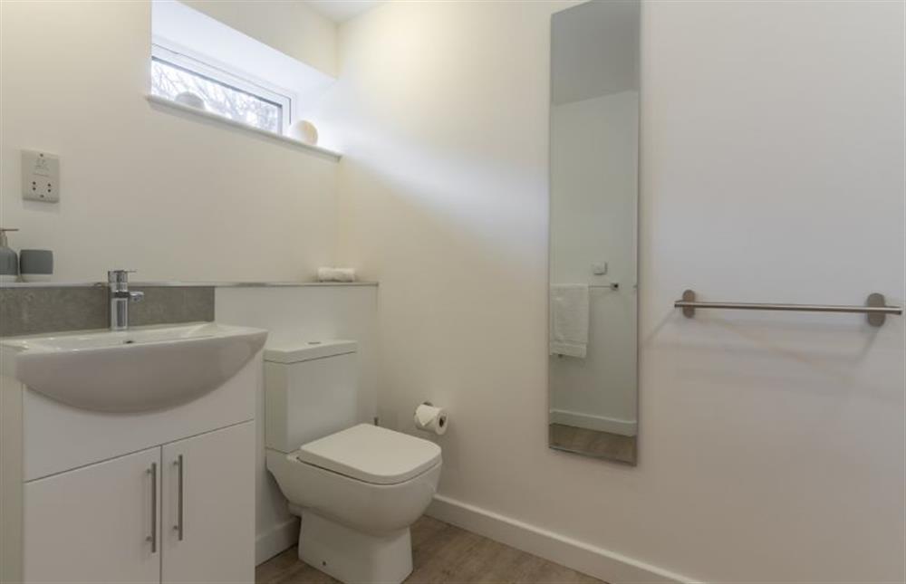 Ground floor: Family bathroom with bath, shower over the bath, WC and wash basin  at Seastiles, Salthouse near Holt