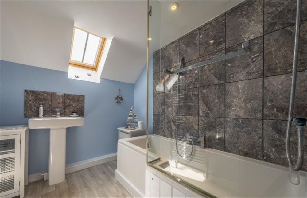 Bathroom with bath with shower over at Seaview Cottage, Old Hunstanton