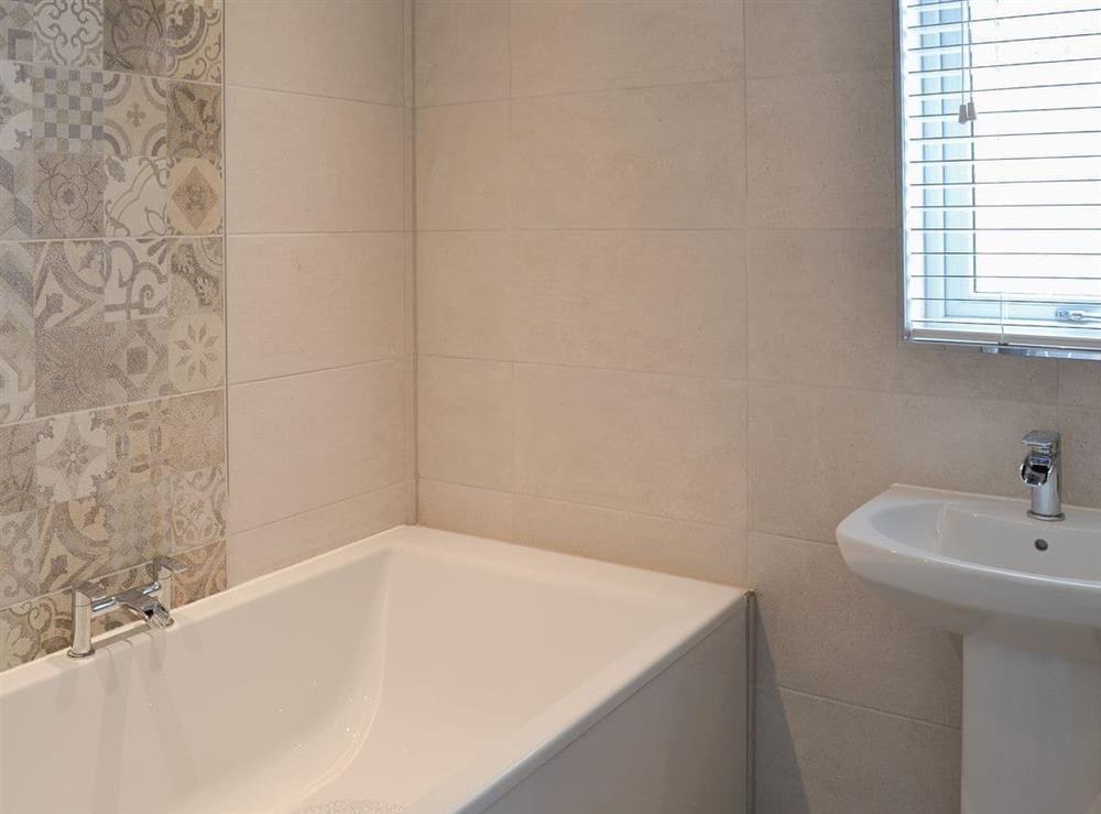 Bathroom with shower cubicle and heated towel rail at Seaview House in Seahouses, near Alnwick, Northumberland, England