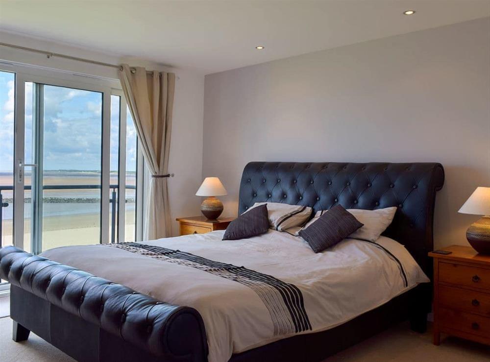 Terrific bedroom with super kingsize bed and sea views at Seaview in Llanelli, Dyfed