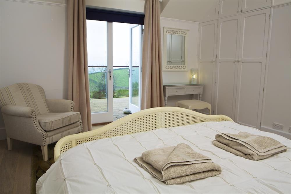 Master bedroom with access to balcony at Seaway House in , Strete
