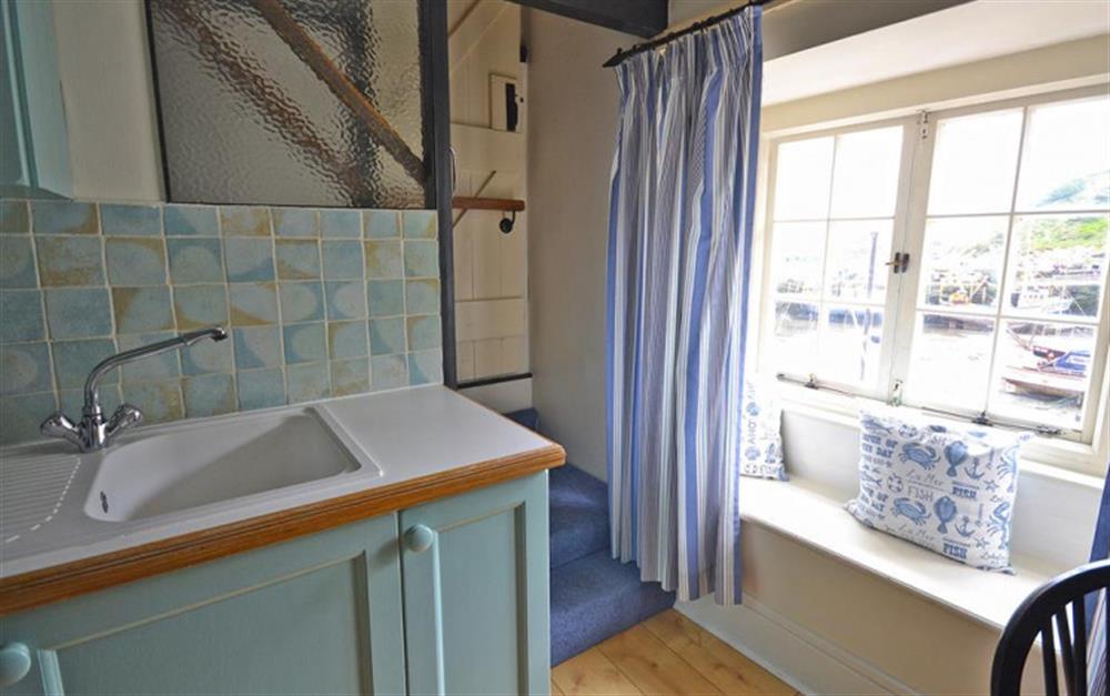 The bright kitchen window with views over the harbour at Seawinds in Polperro
