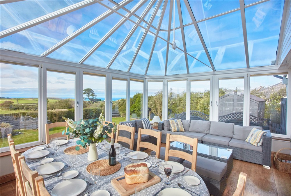 Conservatory with views overlooking the garden and distant sea views at Seawynds, Port Isaac
