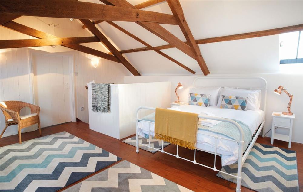 Bedroom with 5’ king-size bed and vaulted ceiling at Seekings Cottage, Knowstone