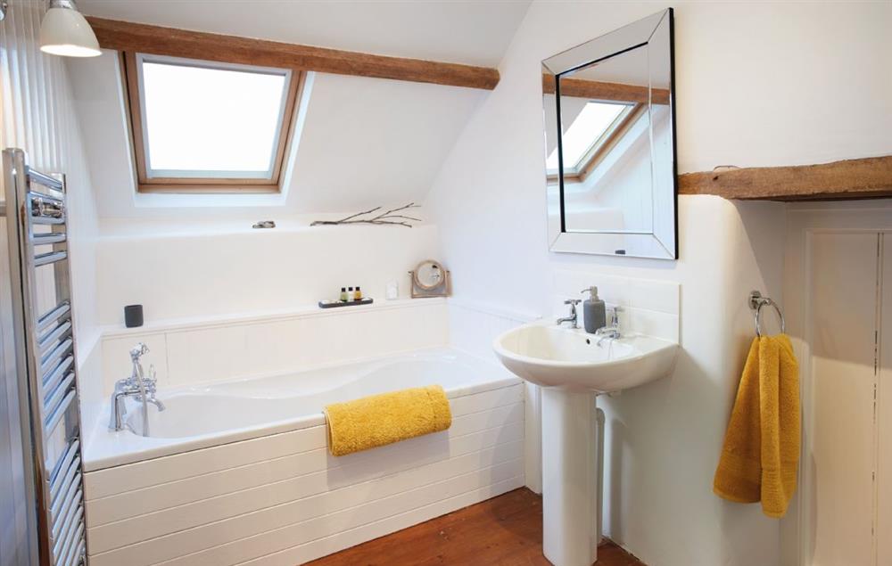 En-suite bathroom with bath and separate shower at Seekings Cottage, Knowstone
