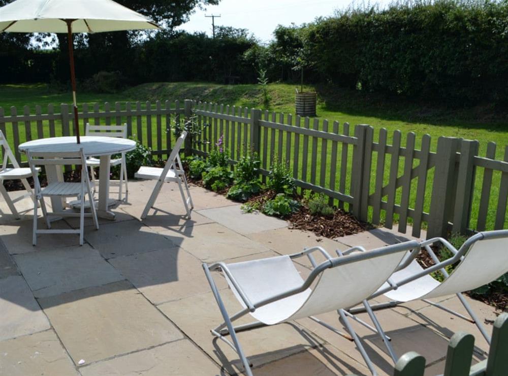 Patio area and view over lawned garden at The Boat House, 