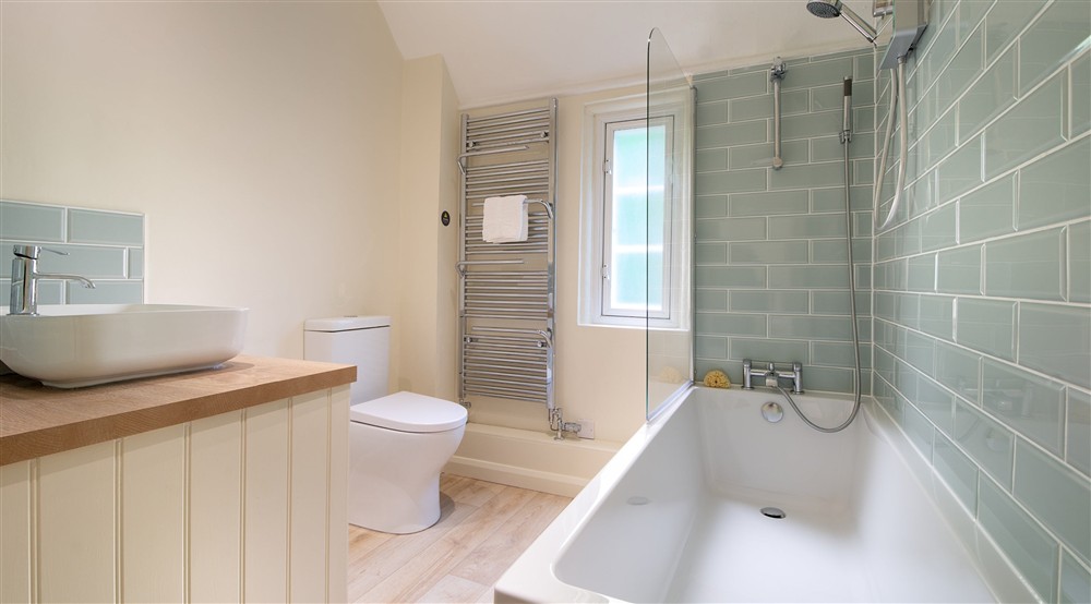 The bathroom, with shower over bath, at Sexton's Lodge in Norwich, Norfolk