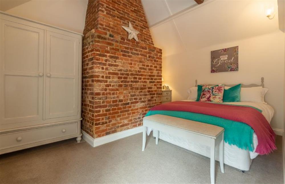 First floor: Master bedroom has character in abundance at Sextons Yard Cottage, Docking near Kings Lynn