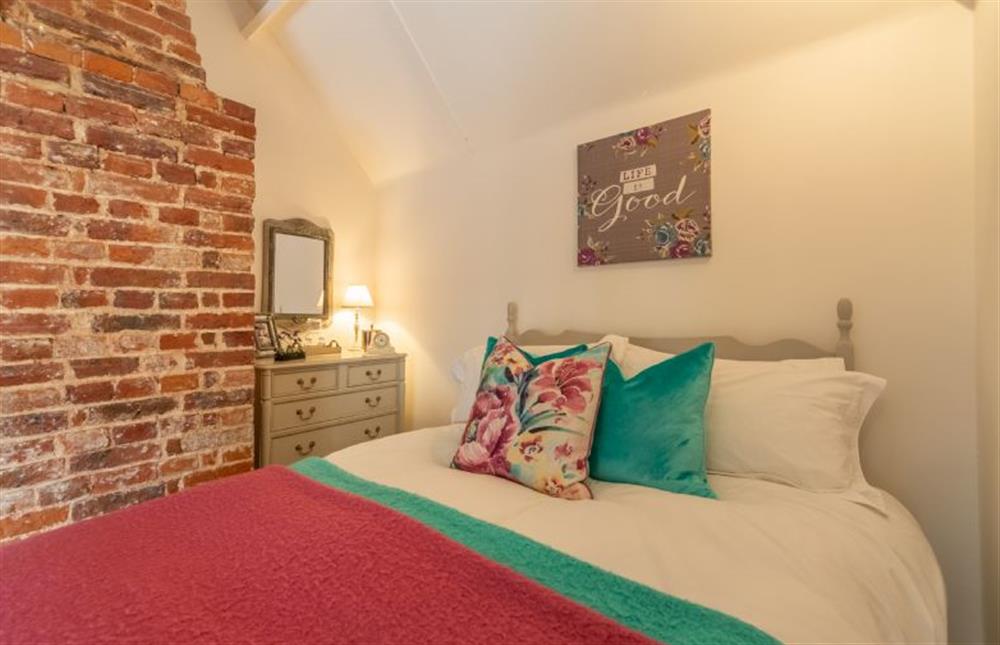 First floor: The comfortable double bed is dressed in luxury linens at Sextons Yard Cottage, Docking near Kings Lynn