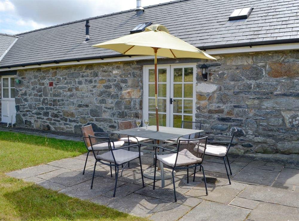 Paved patio area within enclosed rear garden at Sgubor Ucha in Llanrhychwyn, Trefriw, Gwynedd
