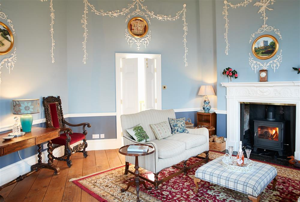 Once a music room, the magnificent drawing room is both elegant and cosy at Sham Castle, Acton Burnell