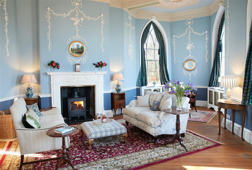 The drawing room with its wood burning stove and beautiful, decorative plaster work at Sham Castle, Acton Burnell