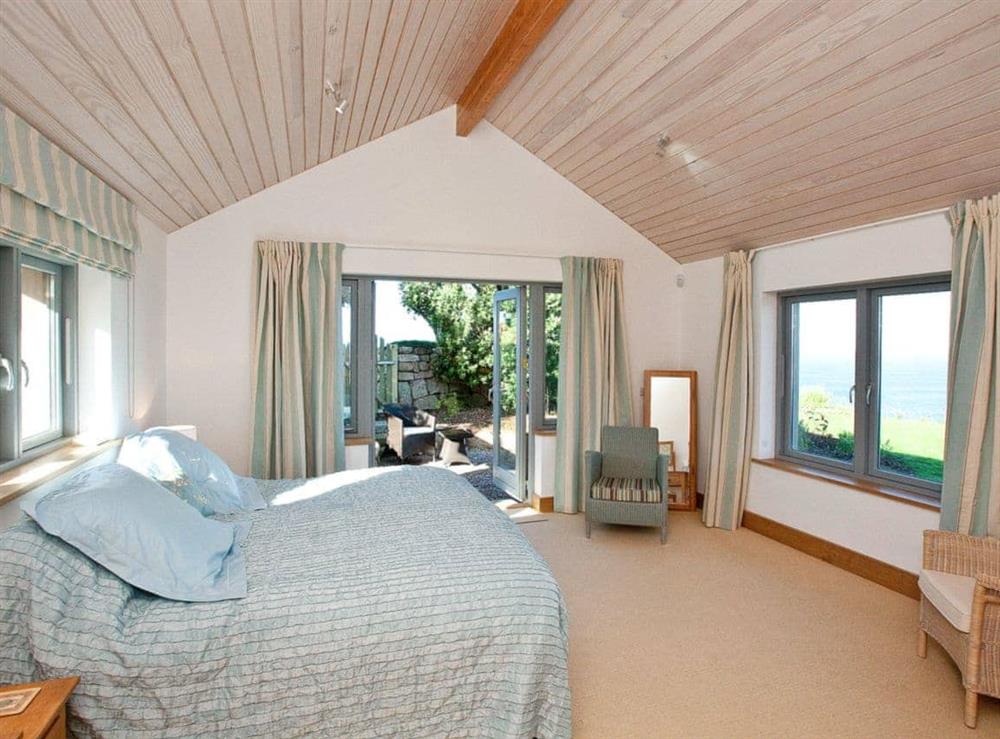 6ft double bedroom with french doors to patio at Shark’s Fin in Sennen, S. Cornwall., Great Britain