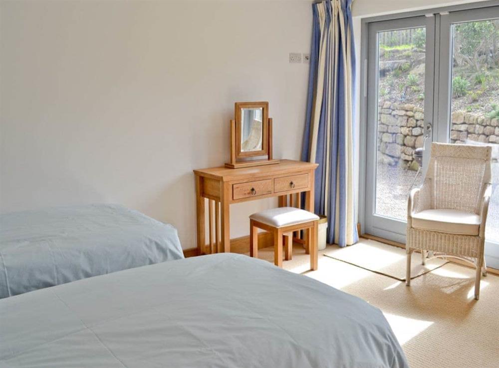 Bright and airy twin bedroom with patio doors to garden at Shark’s Fin in Sennen, S. Cornwall., Great Britain