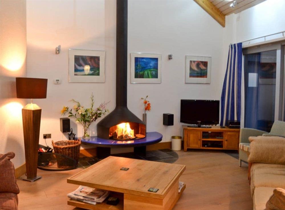 Spacious living room with feature wood burning stove at Shark’s Fin in Sennen, S. Cornwall., Great Britain