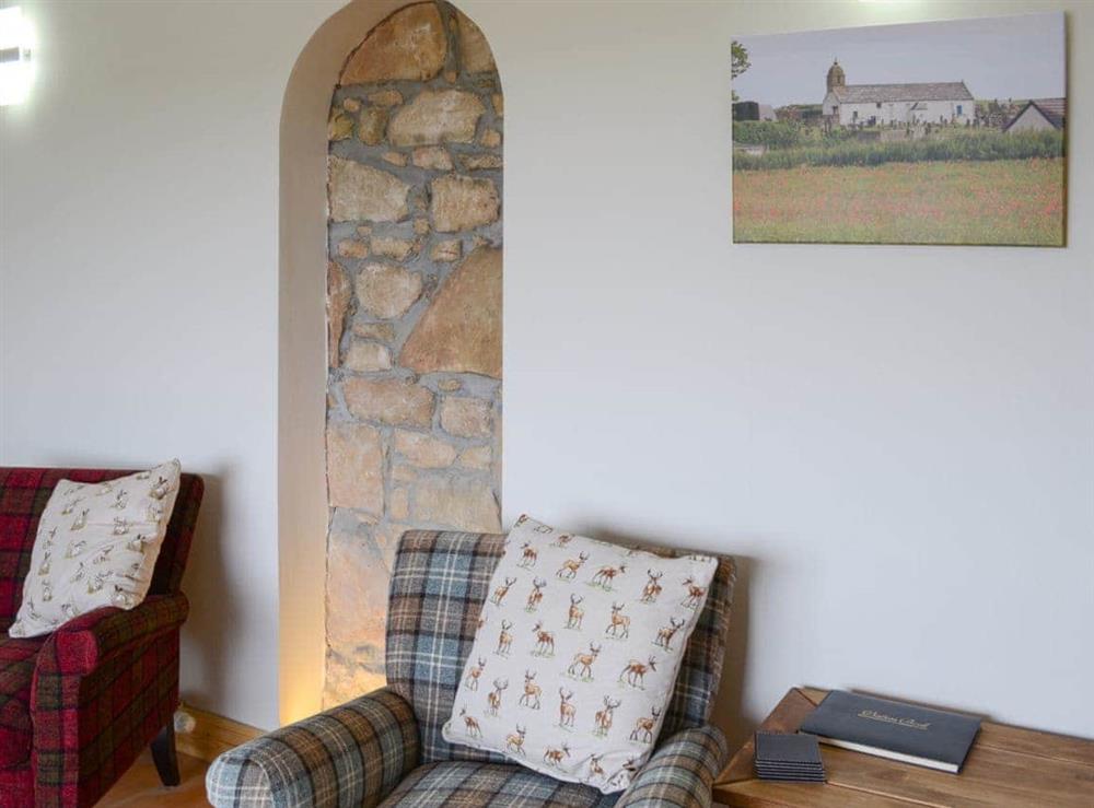 Charming living room with exposed stonework at Sheaf Dale in Portmahomack, near Tain, Northern Highlands, Ross-Shire