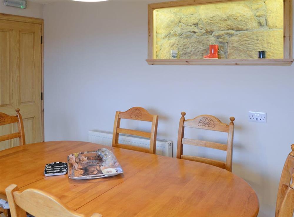 Dining area with feature wall at Sheaf Dale in Portmahomack, near Tain, Northern Highlands, Ross-Shire