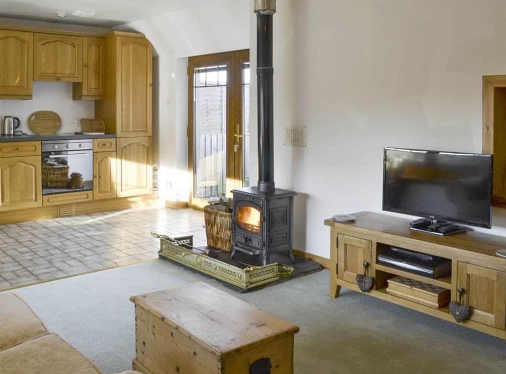 Open-plan living space with a wood burner at Shedend in Nether Dallachy, near Spey Bay, Morayshire