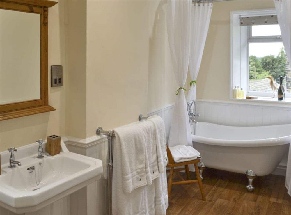Bathroom with roll top bath at Shelduck Cottage in Holmfirth, West Yorkshire