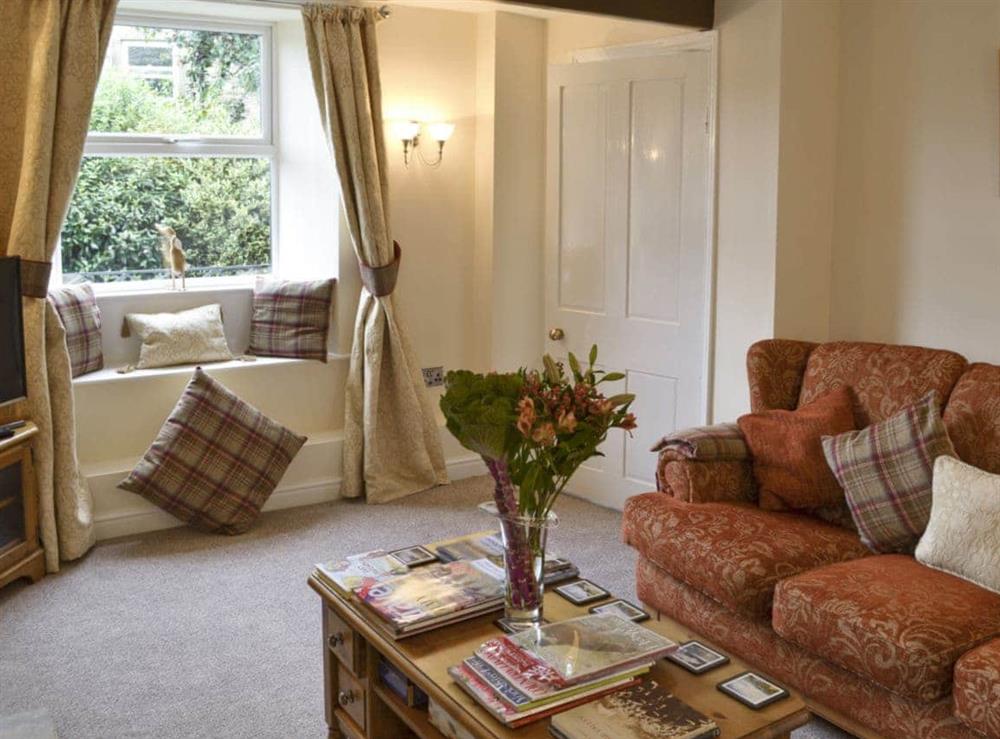 Comfy seating and window seat in lounge at Shelduck Cottage in Holmfirth, West Yorkshire