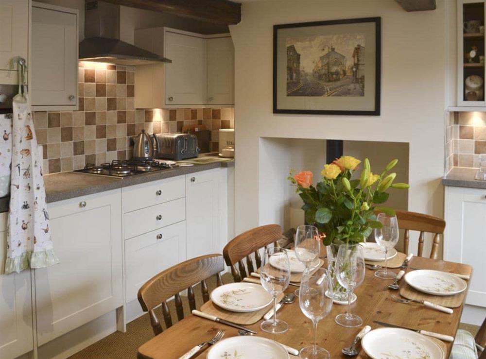 Well-equipped fitted kitchen with dining area at Shelduck Cottage in Holmfirth, West Yorkshire
