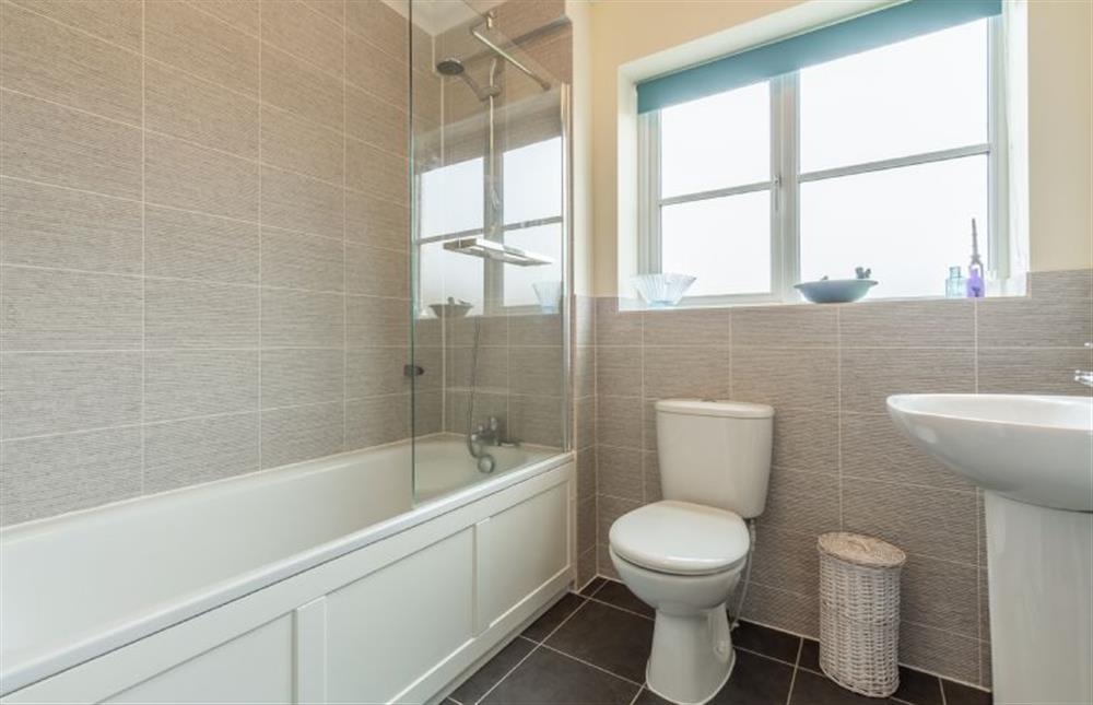 First floor: Bathroom with bath and over head shower at Shellseekers, Snettisham near Kings Lynn