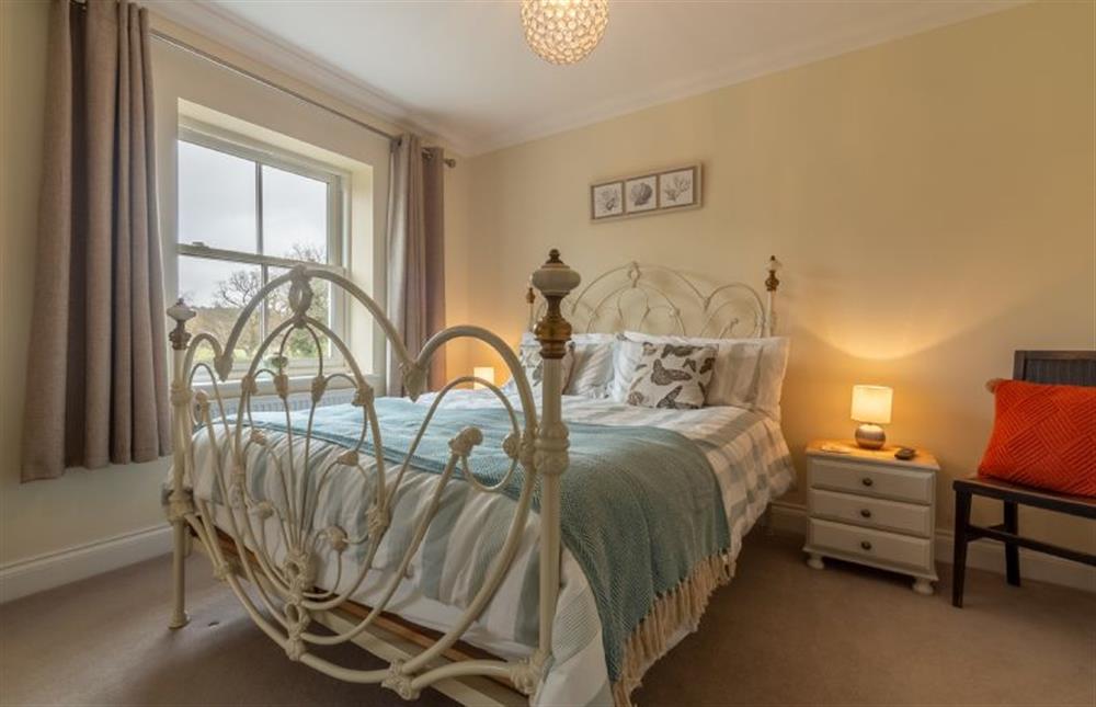 First floor: Master bedroom with a king-size bed at Shellseekers, Snettisham near Kings Lynn
