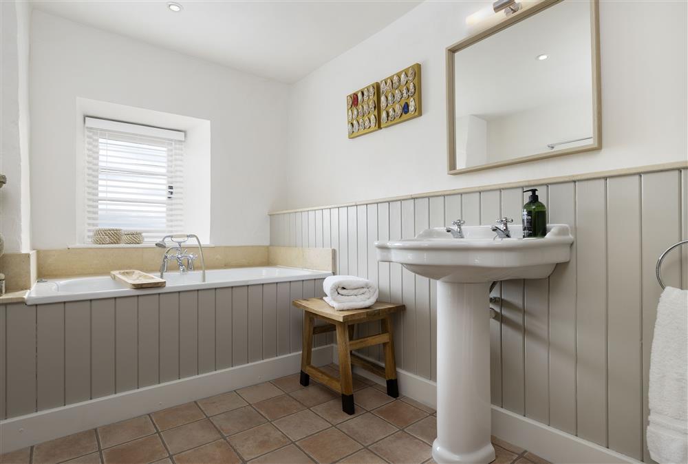 First floor: Family bathroom with bath and overhead shower at Shepherds Cottage, Chipping Norton