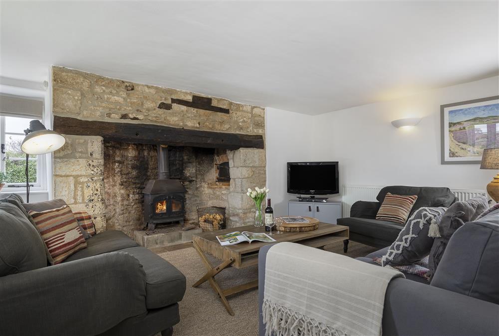 Ground floor: Cosy and comfortable sitting room with wood burning stove at Shepherds Cottage, Chipping Norton