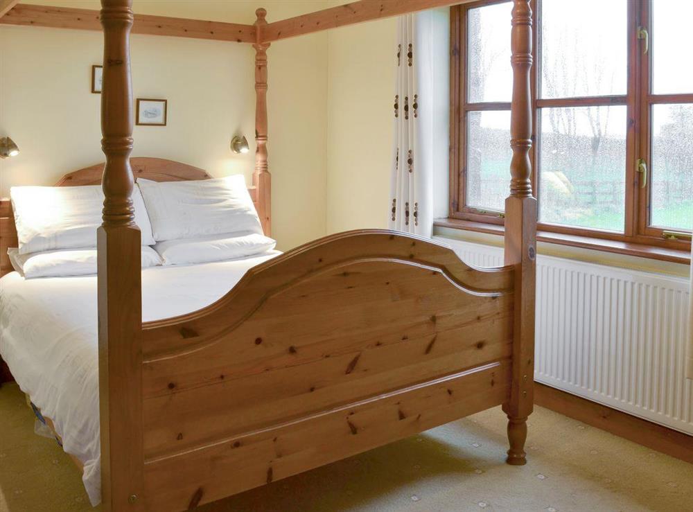 Comfortable four poster bedroom at Elderberry House, 