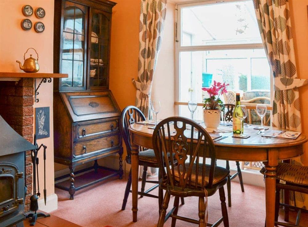 Delightful dining room with window onto the conservatory at Shingle Cottage in Seascale, near Eskdale, Cumbria
