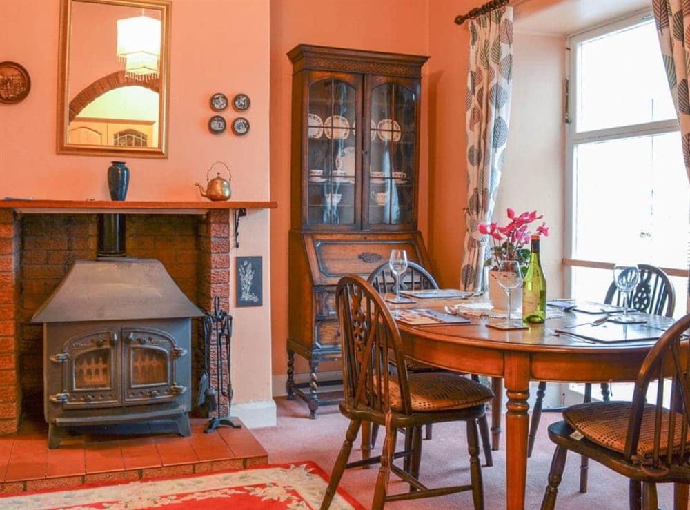 Dining room with large woodburner at Shingle Cottage in Seascale, near Eskdale, Cumbria