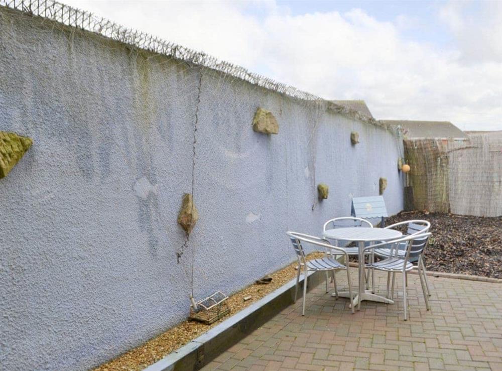 Enclosed rear courtyard with outdoor furniture at Ship Shape in Newbiggin-by-the-Sea, Northumberland