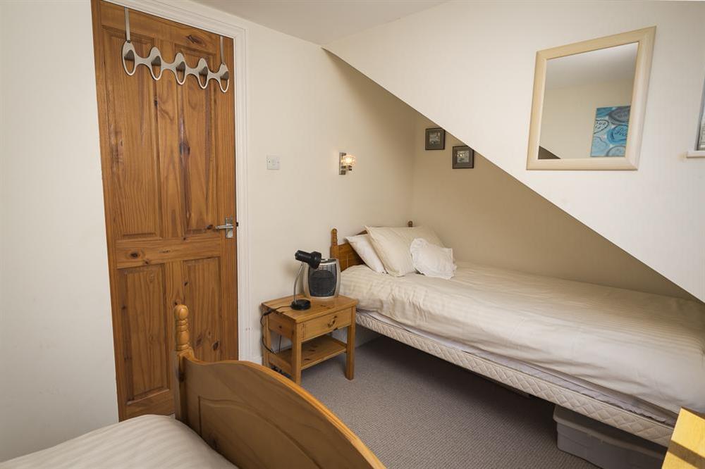 2nd floor (attic) level is a small twin bedroom with two single beds at Shipwrights in 11 Coronation Road, Salcombe