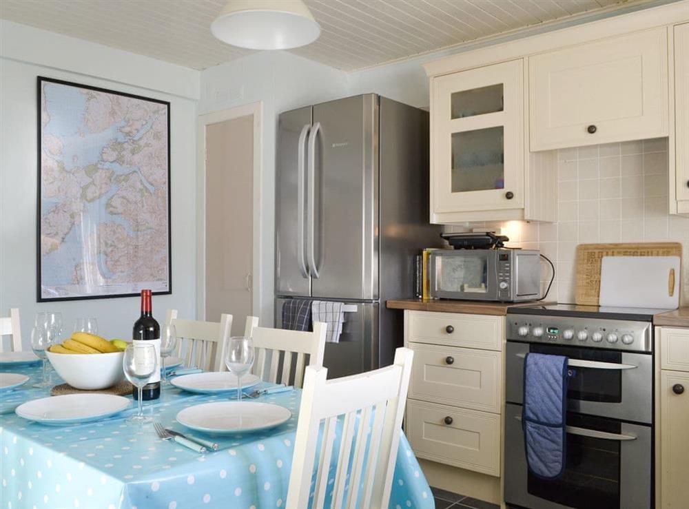 Fully equipped kitchen with dining area at Shore Cottage in Arnisdale, near Glenelg, Ross-Shire