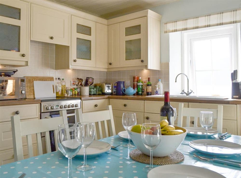 Well-equipped kitchen with dining space at Shore Cottage in Arnisdale, near Glenelg, Ross-Shire