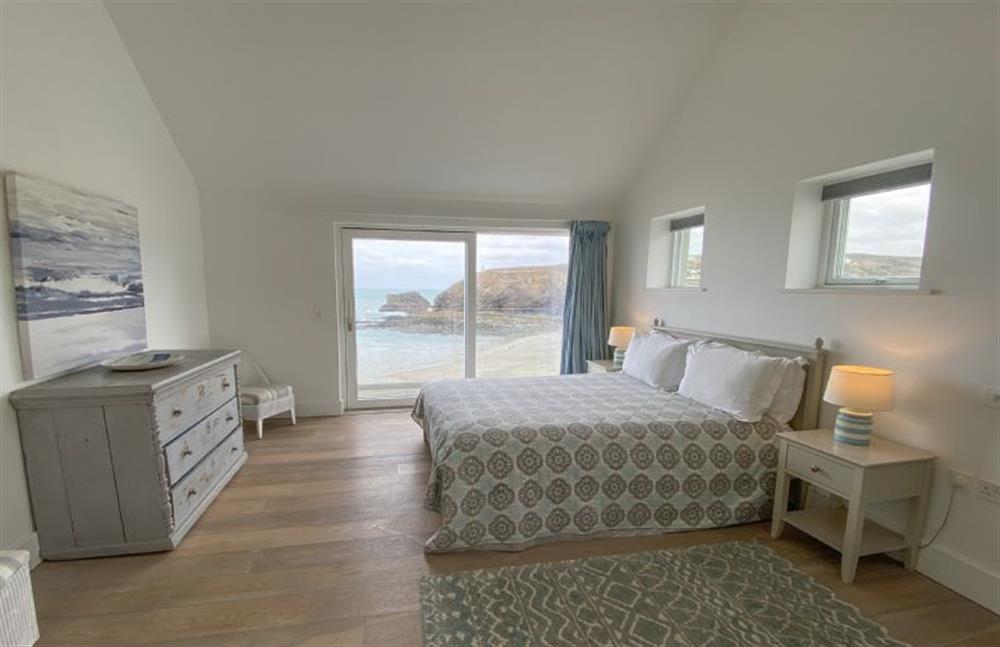 Bedroom two with 5’ king size bed, patio door to private balcony and en-suite shower room at Shore Edge, Portreath