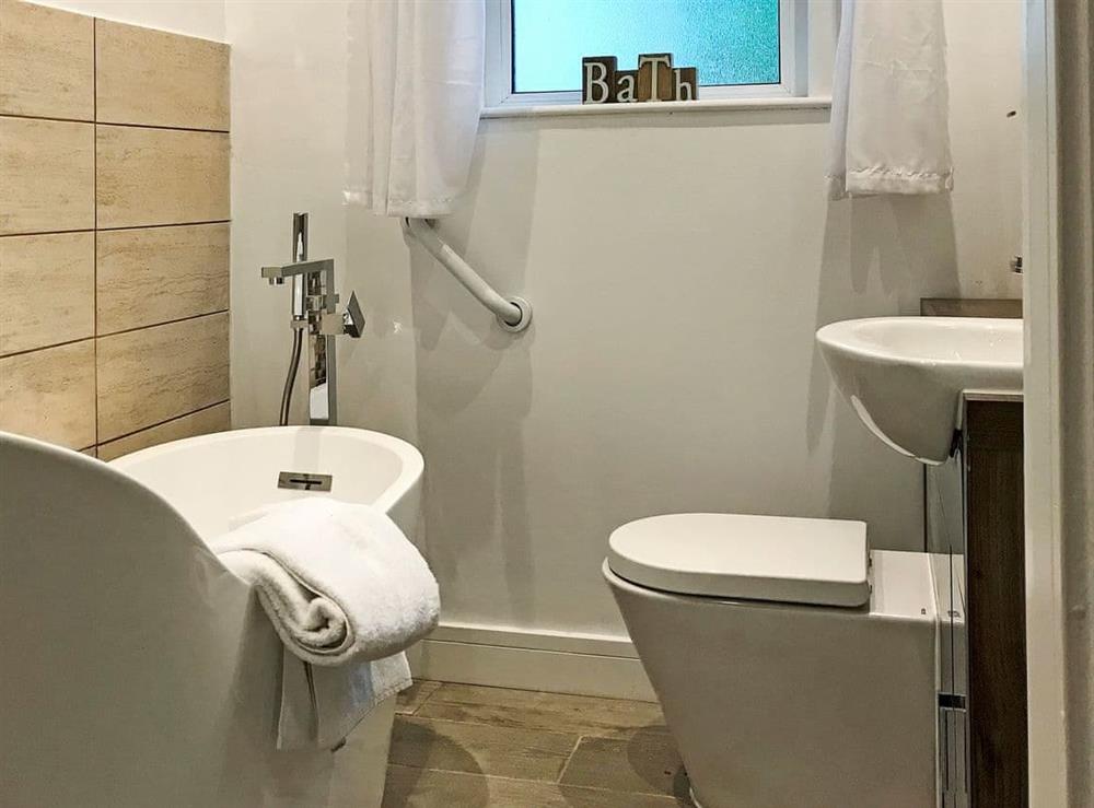Luxurious bathroom with bath and walk-in shower at Shoreline in Goodrington, near Paignton, Devon