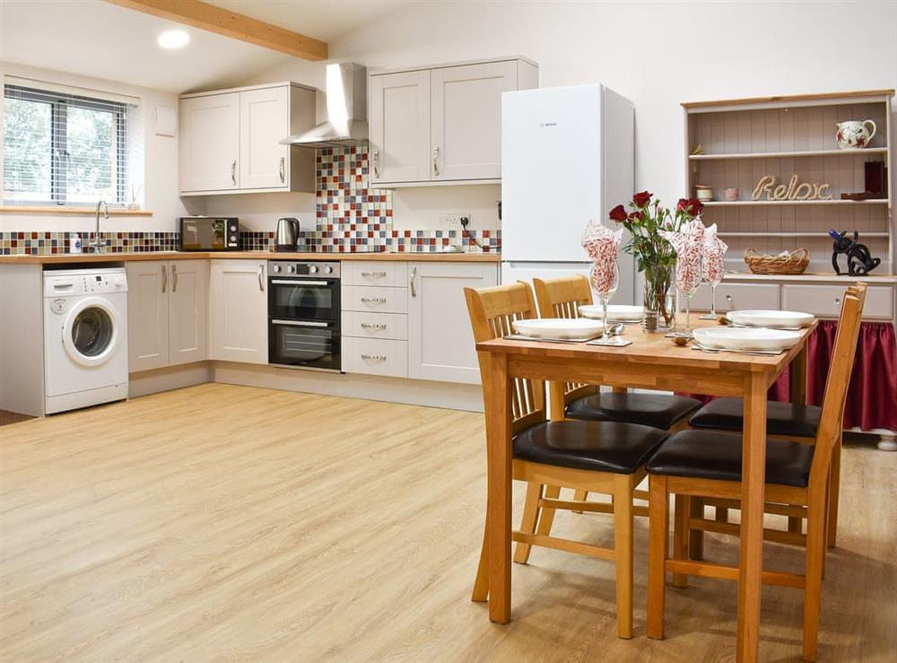 Dining area and adjacent kitchen at Sids Place in Ringwood, Dorset