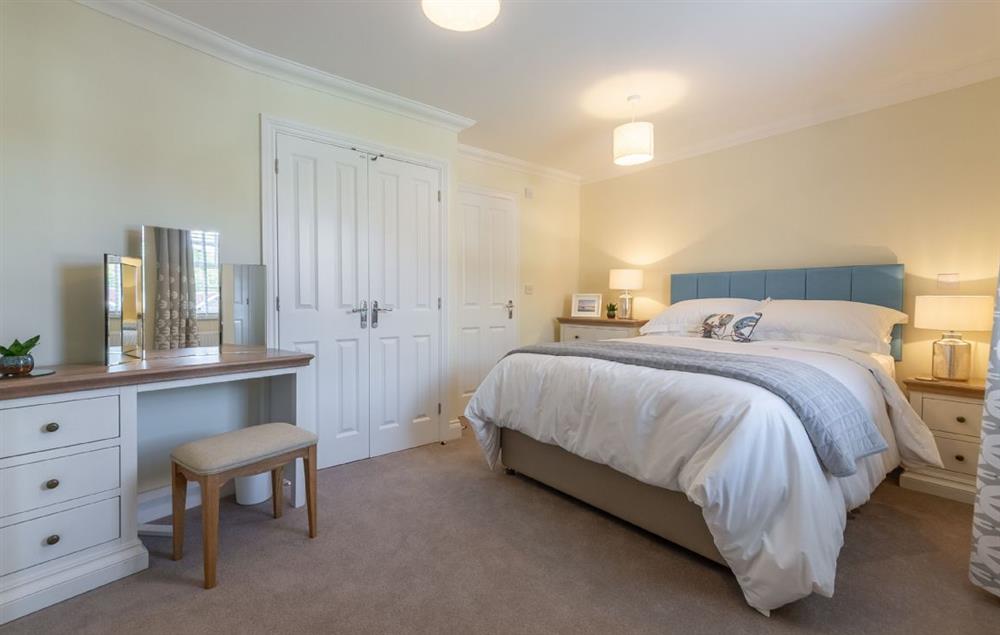 Bedroom one with king size bed and en-suite shower room (photo 2) at Silver Birches, Holt