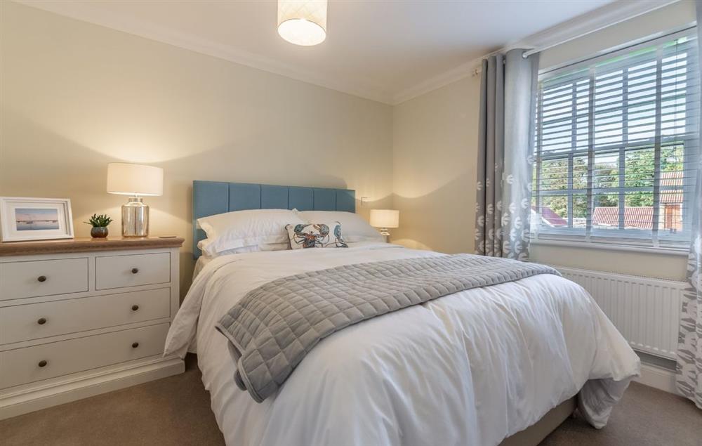 Bedroom one with king size bed and en-suite shower room at Silver Birches, Holt