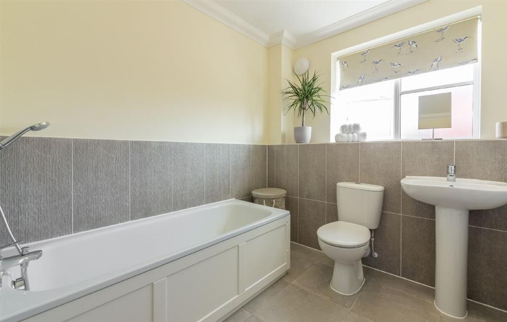 Family bathroom with bath and hand held shower attachment at Silver Birches, Holt