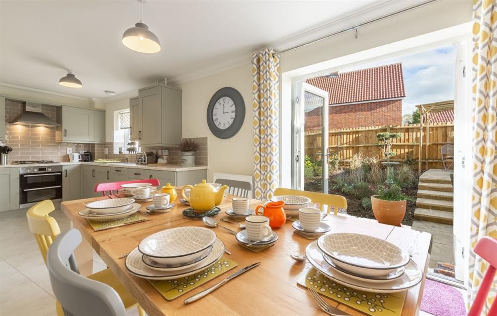 Well equipped kitchen/dining room with french doors leading to the courtyard garden at Silver Birches, Holt