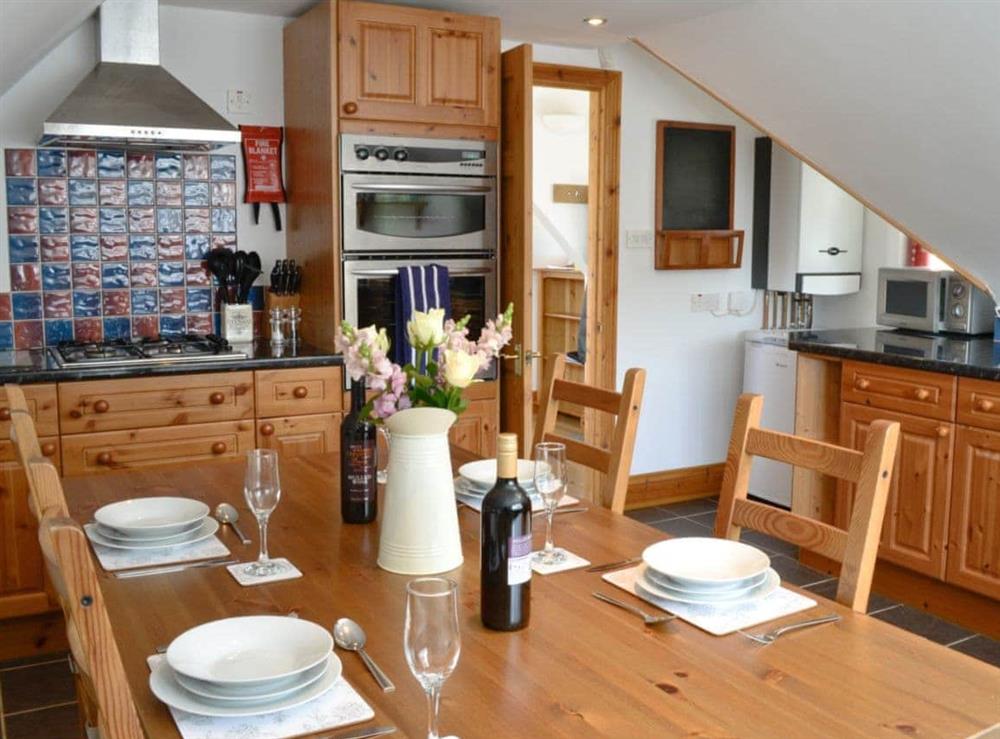 Well-equipped fitted kitchen with spacious dining area at Silver Cottage in Combe Martin, near Ilfracombe, Devon