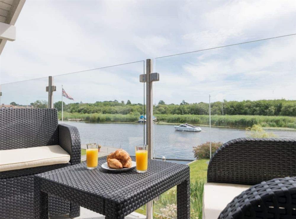 Outdoor furniture on master suite balcony at Silver Dawn in Horning, near Wroxham, Norfolk