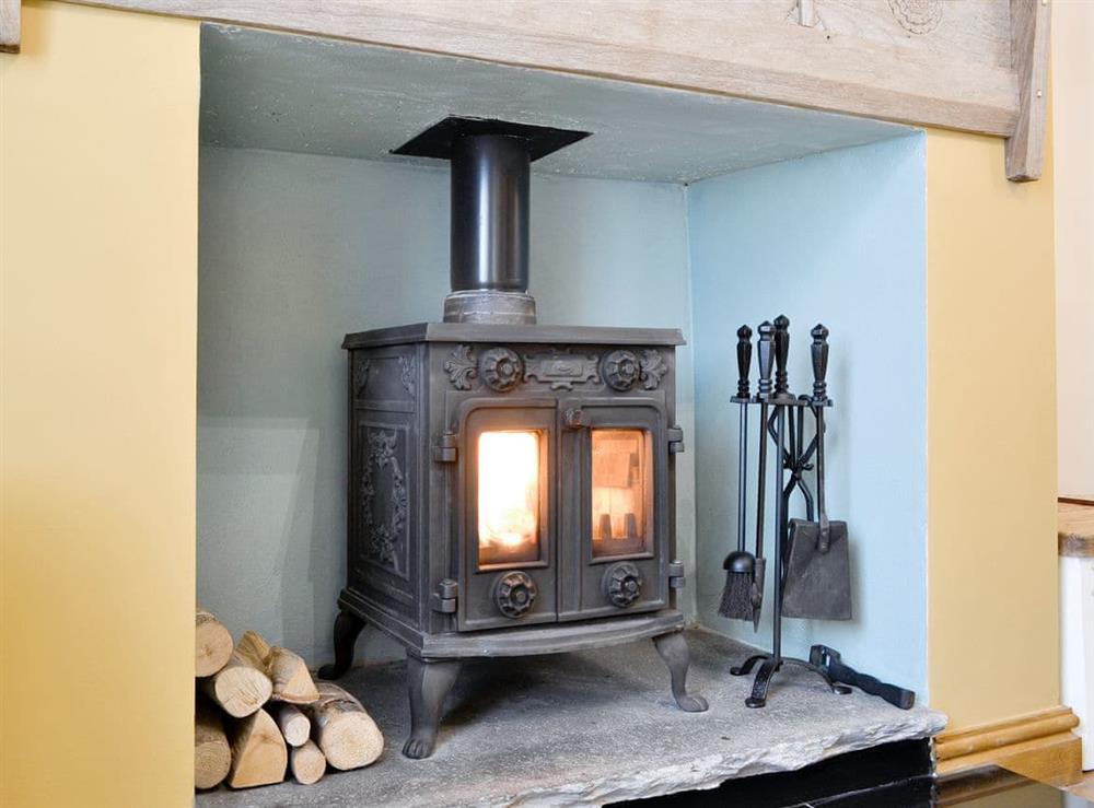 Warm and welcoming wood burner at Skelmorlie Cottage in Portinscale, near Keswick, Cumbria