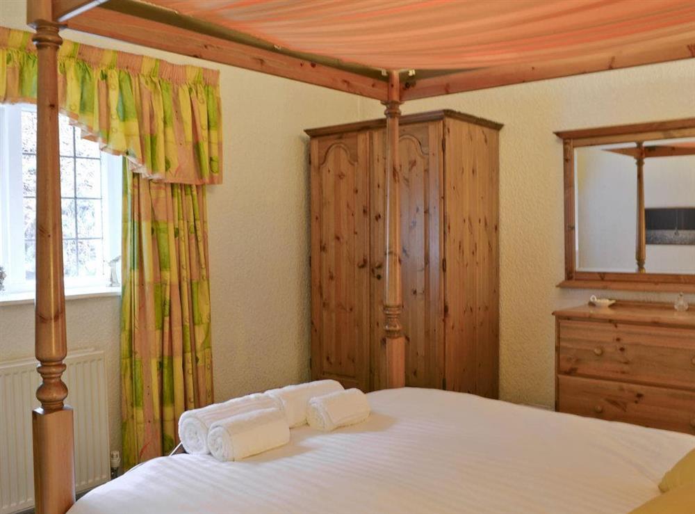 Comfortable four poster bed at Skiddaw Apartment in Ambleside, Cumbria
