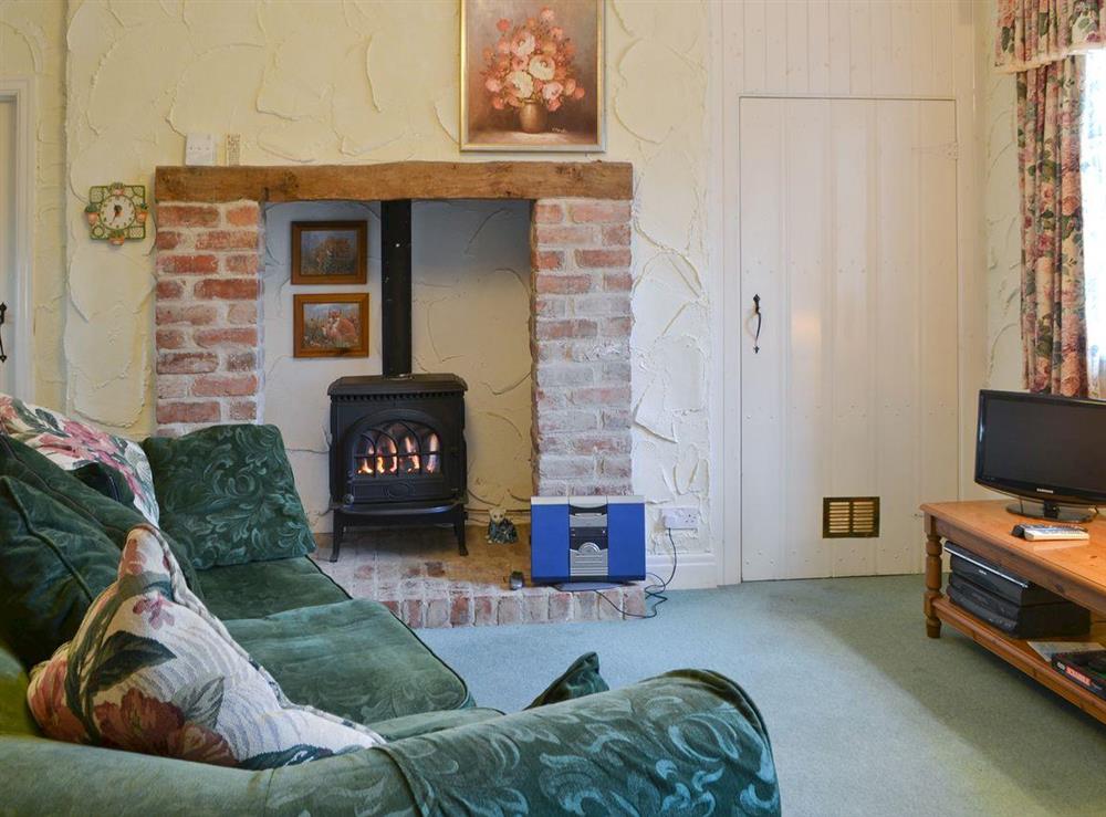 Cosy lounge area with heritage fireplace at Skiddaw Apartment in Ambleside, Cumbria