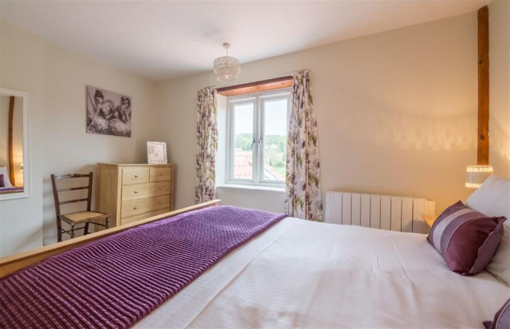 First floor: The master bedroom has a king-size bed at Skimming Stones, North Creake near Fakenham
